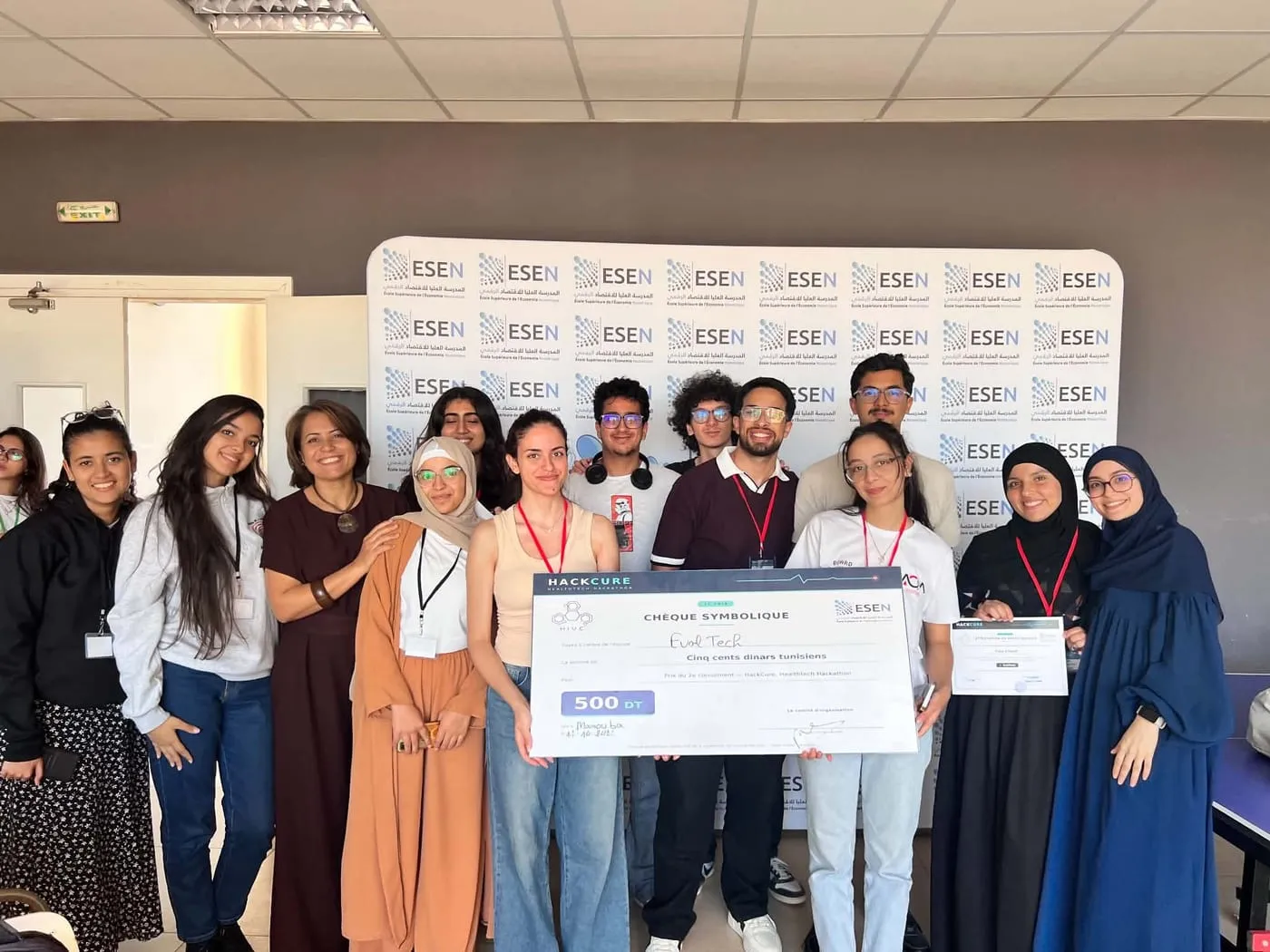 Team EvolTech with the HackCure 2nd-place cheque at ESEN, Ines among them holding her certificate